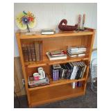 Wooden Bookshelf with Assorted Books, Media, and Collectibles