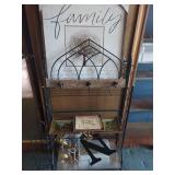 Metal Storage Rack with Decorative Wall Art and Assorted Decor