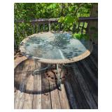 Round Glass Top Patio Table with Wicker Trim and Cast Metal Base