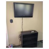 Sony Bravia Television with Black Three-Shelf Media Stand and Remotes