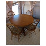 Round Oak Pedestal Dining Table with Four Spindle Back Chairs