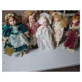 Five Porcelain Dolls with Fabric Clothing