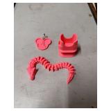 PINK IPHONE CORD CHARGER HOLDER, PINK DISNEY KEYCHAIN, AND PINK FIGIT DRAGON