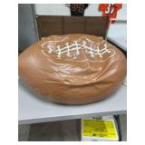 This is a tan imitation PU leather football-shaped bean bag chair