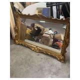 57.5 INCHES X 33.5 INCHES ORNATE VINTAGE BAROQUE -STYLED GOLD-GILT WALL MIRROR FEATURING A HEAVILY Dmirror featuring DETAILED MOLDED FRAME WITH TRADITIONAL SCROLL AND SHELL MOTIF