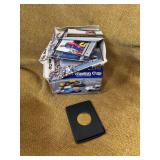 BOX OF WINSTON CUP RACING CARDS AND A EARNHARDT COIN.