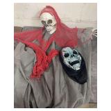 HALLOWEEN HANGING DECORATION AND A SKELETON MASK.