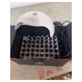 MEFA NAIL DRYER AND BOX OF NAIL POLISHES.