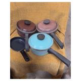 THREE PIECES OF CLUBWARE POTS, LIDS  AND A LITTLE SKILLET.