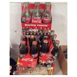 FOUR SETS OF NASCAR COCA COLA SPECIAL ADDITIONAL CONTAINERS. THREE BOTTLE AND ONE 12 PACK OF CANS CANS HAVE LEAKED OUT