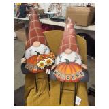 TWO METAL GNOMES FOR YARD DECORATION.  BOTH SAY WELCOME AND ARE ABOUT TWO FEET TALL.  TWO GNOME LITTLE METAL YARD STAKES HOLD FLOWERS