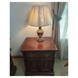 Wooden Nightstand with Brass Tone Hardware and Table Lamp Combination