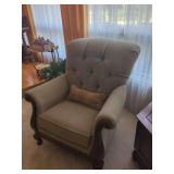 Upholstered Armchair with Tufted Back and Carved Wood Accents