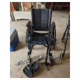 Black Folding Wheelchair with Detachable Footrests and Quad Cane