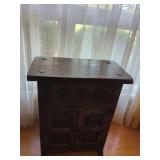Spanish Colonial Style Wooden Cabinet with Carved Panels and Metal Accents