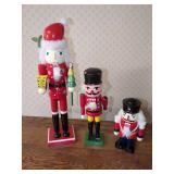 Collection of Three Wooden Nutcracker Figures with Holiday Motifs