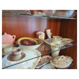 Ceramic and Porcelain Tableware Assortment Displayed in Cabinet