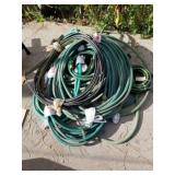 Assorted hoses and metal half drum