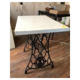 Table on wrought iron sewing machine stand Table on wrought iron sewing machine stand