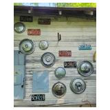 Hubcaps, license plates, etc hanging on south Hubcaps, license plates, etc hanging on south