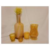 Yellow colored glass vases and candleholders