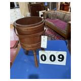 Wood bucket on three legs.
