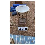 Small sink on old metal rack
