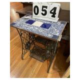 Table on a Singer sewing machine frame