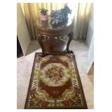 Round accent table, rug, and purple decor