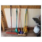 assortment of seven brooms