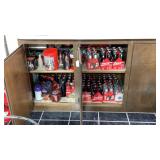Two shelves of Coca-Cola bottles and tins Two shelves of Coca-Cola bottles and tins