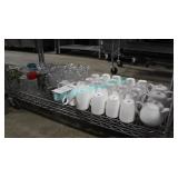 LOT, SHELF OF MUGS, TEAPOTS, CREAMERS + GLASSSES
