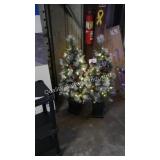 2 prelit potted trees