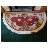 Half circle rug approximately 4 ft long 2 ft wide