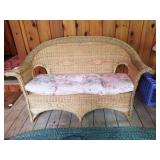 Wicker settee with cushion