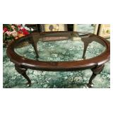 Oval wood glass topped coffee table with