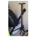 Tall wood plant stand with lot of curtain rods