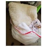 Bag if assorted bath towels and bath rug