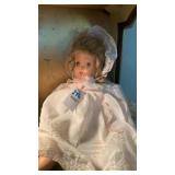 Older baby glass doll, porcelain doll in blue