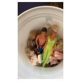 Plastic tub various barbies and dolls
