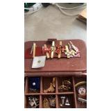 Case filled with various cuff links , tie pins ,