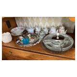 Shelf lot of teapots serving pieces