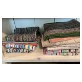 Shelf lot of rugs