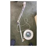 Lighted magnifier on adjustable arm