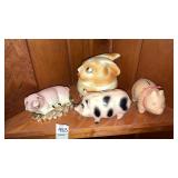 Shelf of piggy banks, pig figurine, bunny jar