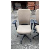 2 tan office chairs on rollers