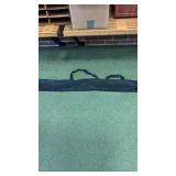 Box full of 4ft black carrying cases with zipper