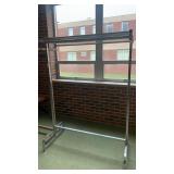 Metal coat hanger with rack above