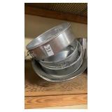 Lot full of cheesecake pans , cake pans