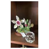 Small hummingbird and flower stature with glass